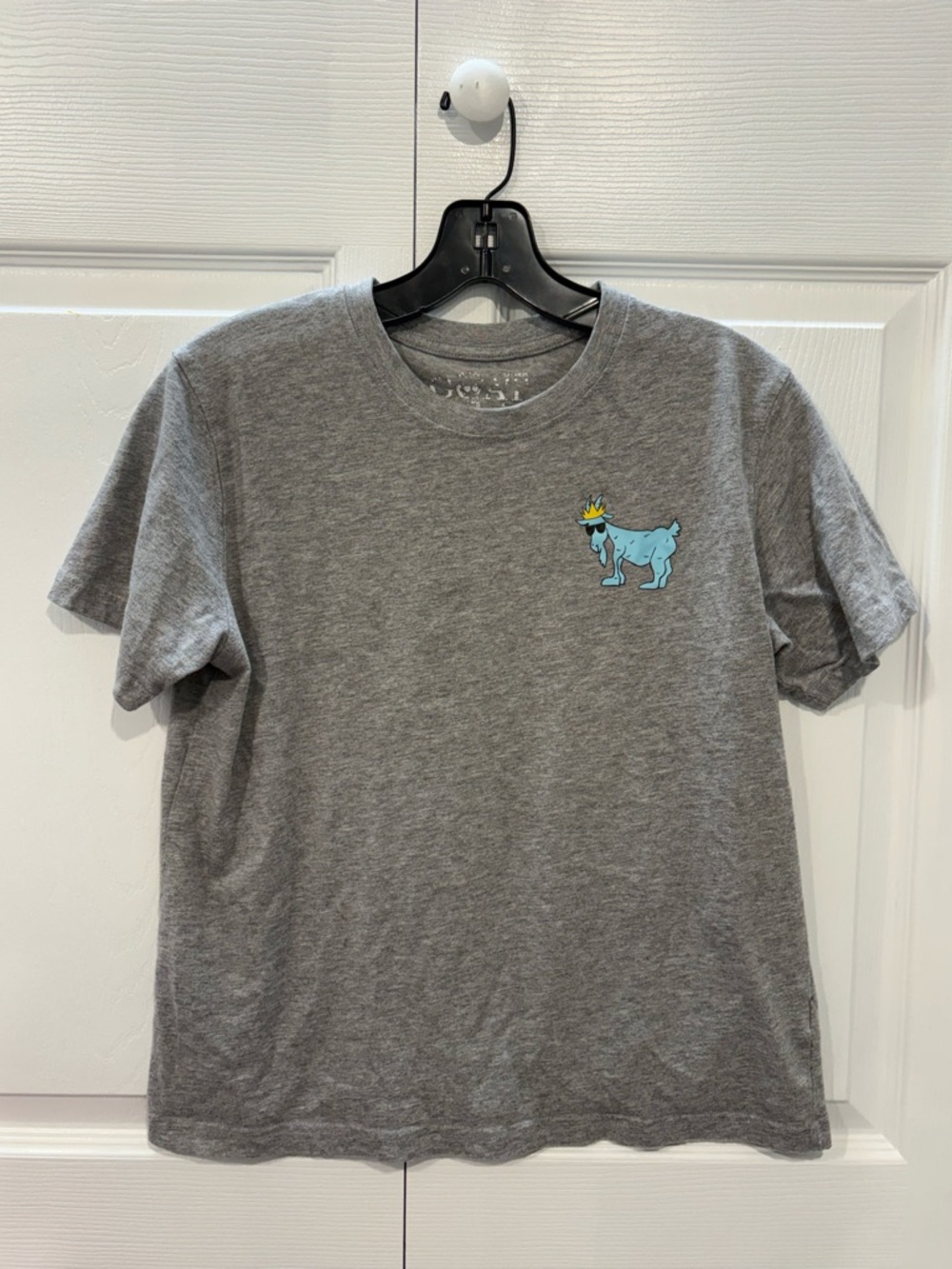 GOAT USA OG T-shirt features a small, light blue graphic of "Chuck the Goat”